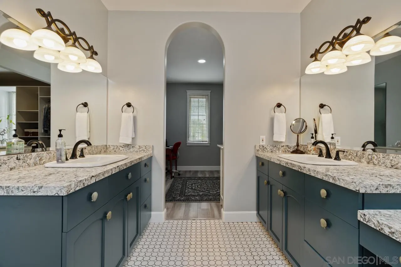 425 Sea Lane La Jolla, CA 92037 - Photo 26 of 41 a bathroom with a granite countertop sink a toilet and a mirror