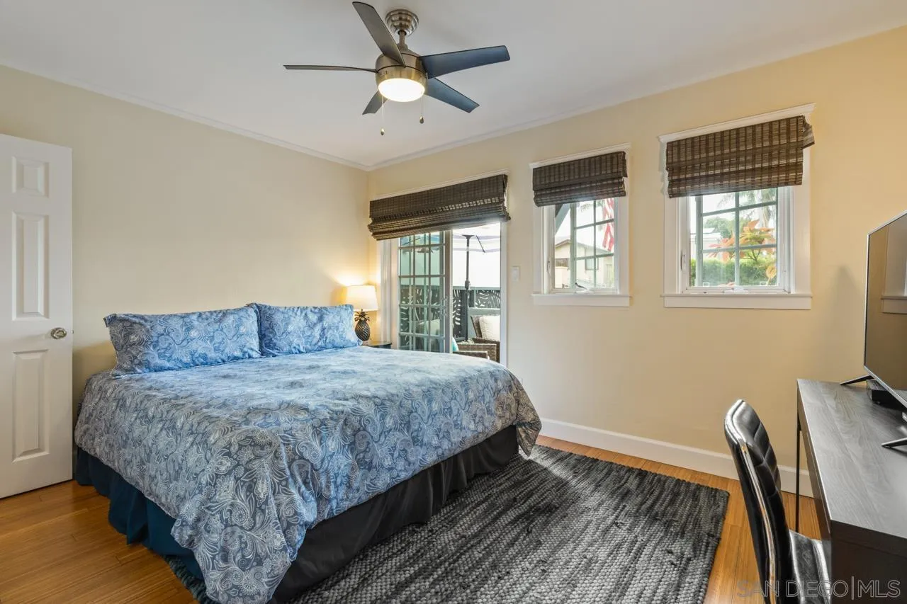 425 Sea Lane La Jolla, CA 92037 - Photo 36 of 41 a bedroom with a large bed chandelier and a window