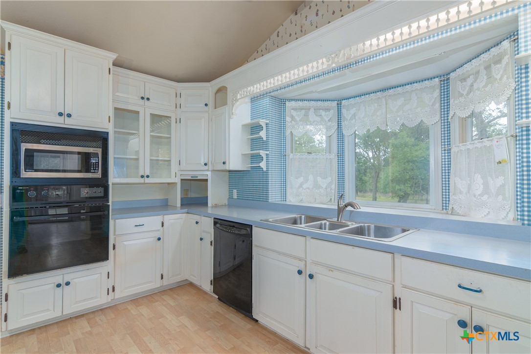 2981 Vivroux Ranch Road Seguin, TX 78155 - Photo 13 of 43 a kitchen with a sink cabinets and window