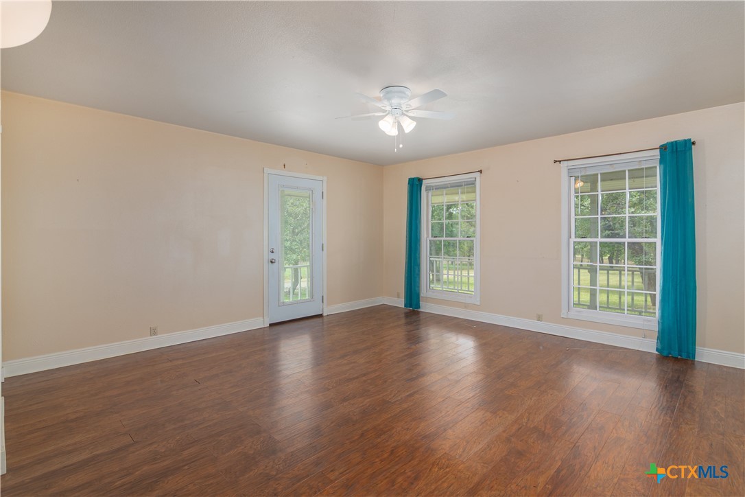 2981 Vivroux Ranch Road Seguin, TX 78155 - Photo 19 of 43 a view of an empty room with wooden floor and a window