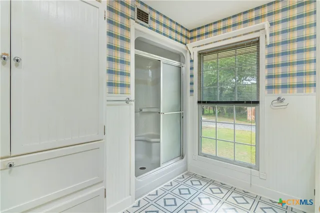a bathroom with a sink and a window