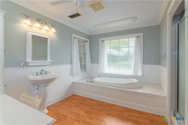a bathroom with a tub and shower