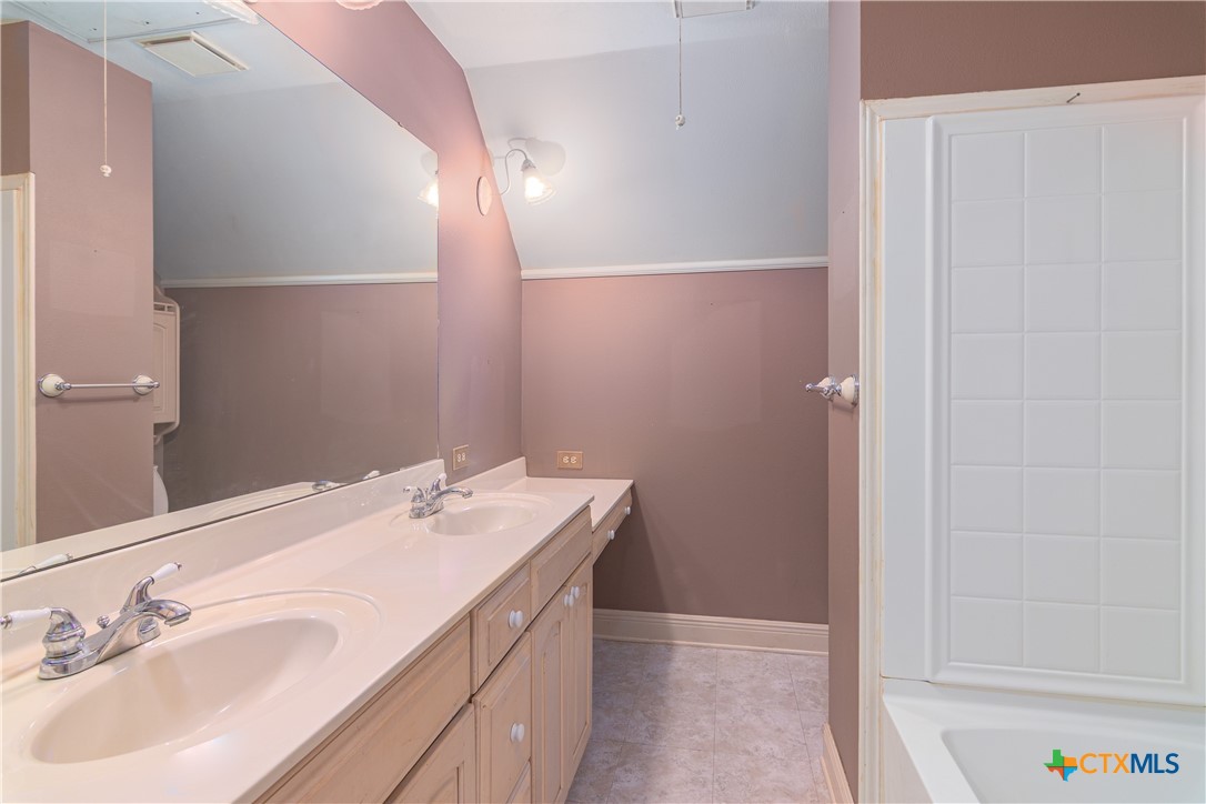 2981 Vivroux Ranch Road Seguin, TX 78155 - Photo 30 of 43 a bathroom with a sink and a mirror