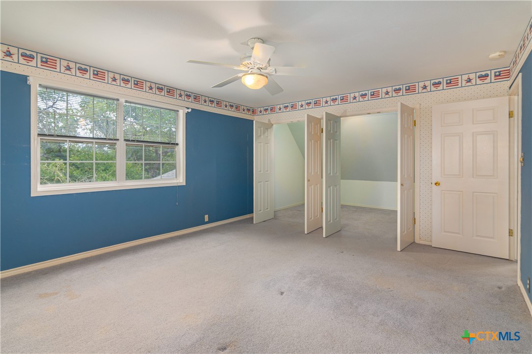 2981 Vivroux Ranch Road Seguin, TX 78155 - Photo 35 of 43 an empty room with chandelier fan and windows