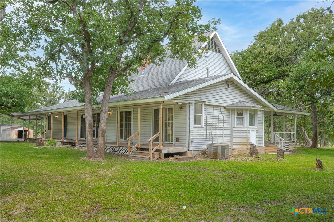 2981 Vivroux Ranch Road Seguin, TX 78155 - Photo 41 of 43 a front view of house with a garden and trees