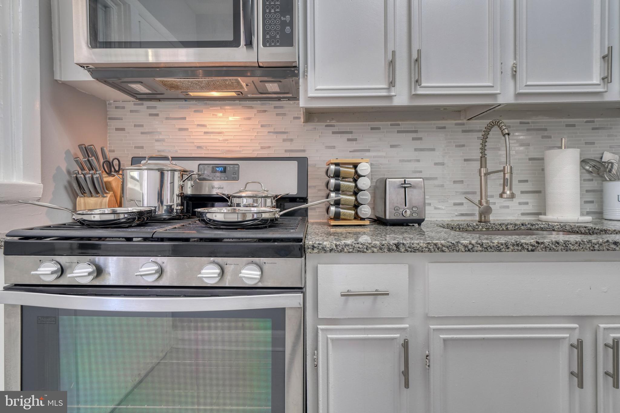 2124 Redthorn Road Baltimore, MD 21220 - Photo 13 of 39 a kitchen with granite countertop white cabinets and appliances