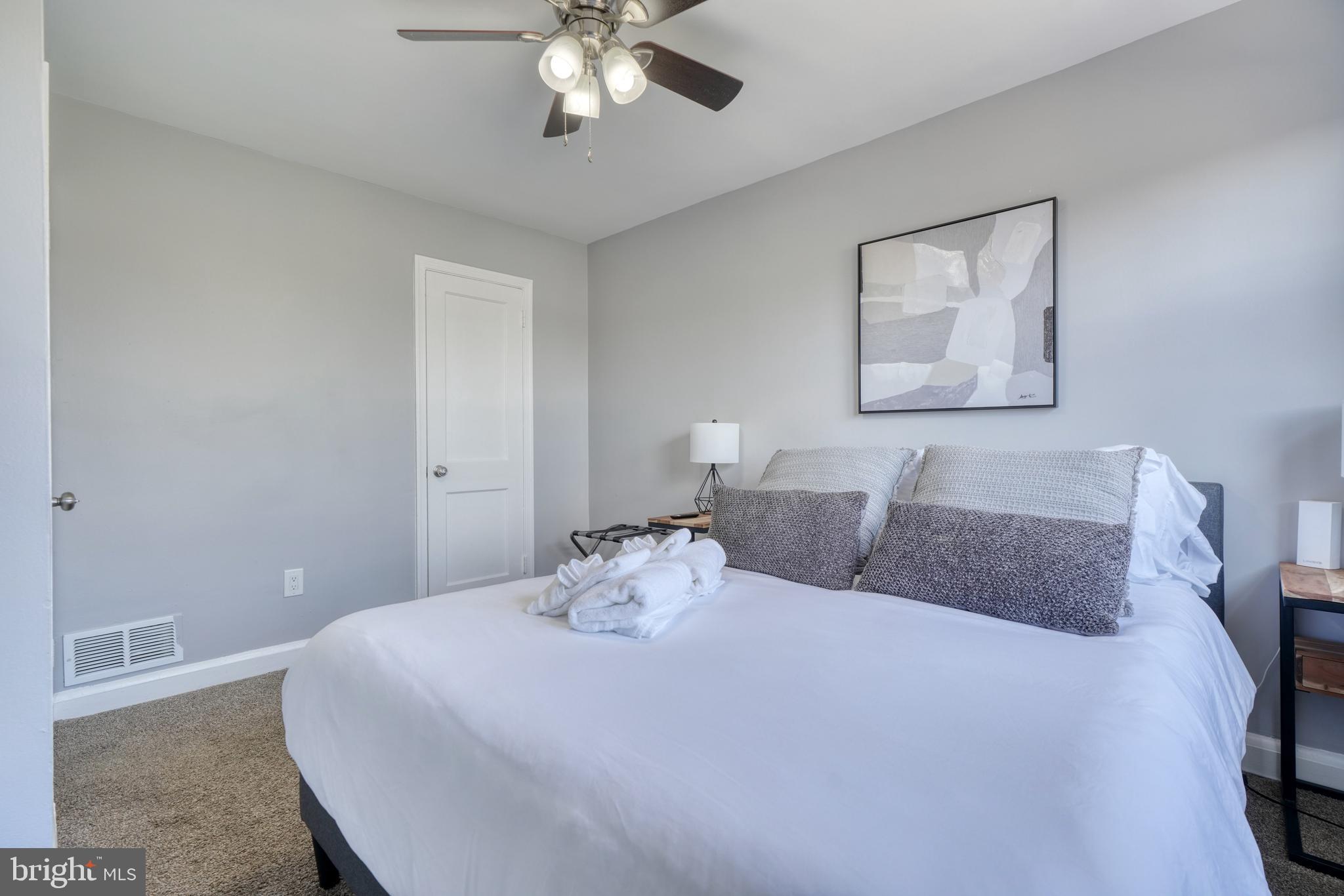 2124 Redthorn Road Baltimore, MD 21220 - Photo 15 of 39 a bedroom with a bed and a chandelier