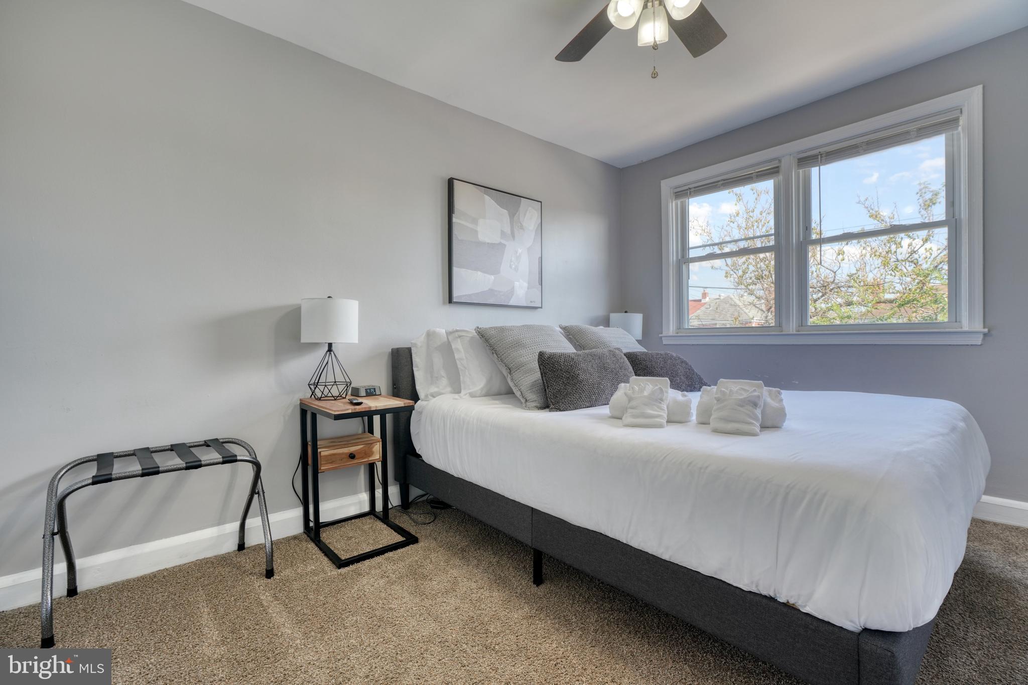 2124 Redthorn Road Baltimore, MD 21220 - Photo 17 of 39 a bedroom with a bed and a chandelier