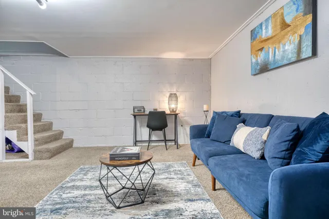 a living room with furniture and a rug