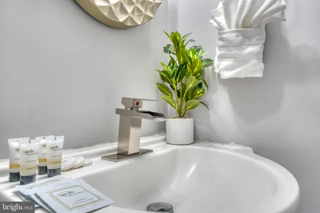a white vase with flowers on a table