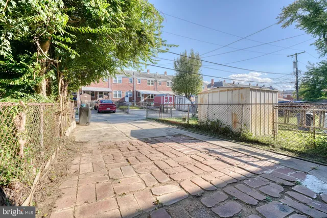 a view of a street with a car parked in front of it