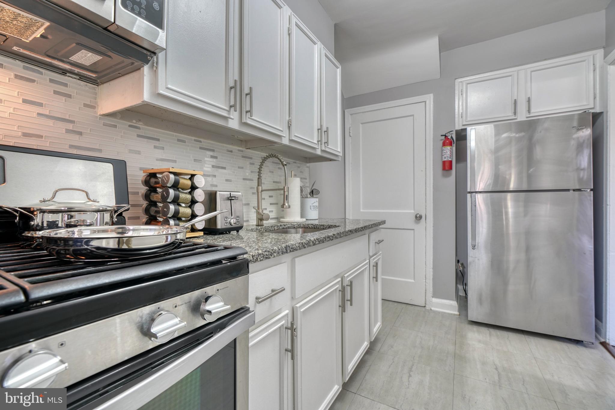 2124 Redthorn Road Baltimore, MD 21220 - Photo 4 of 39 a kitchen with appliances a sink and cabinets