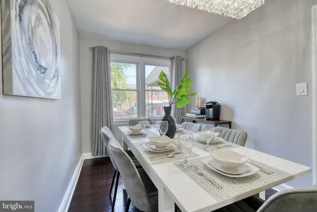 a dining room with furniture and wooden floor