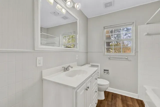 a bath room with a toilet and a bath tub