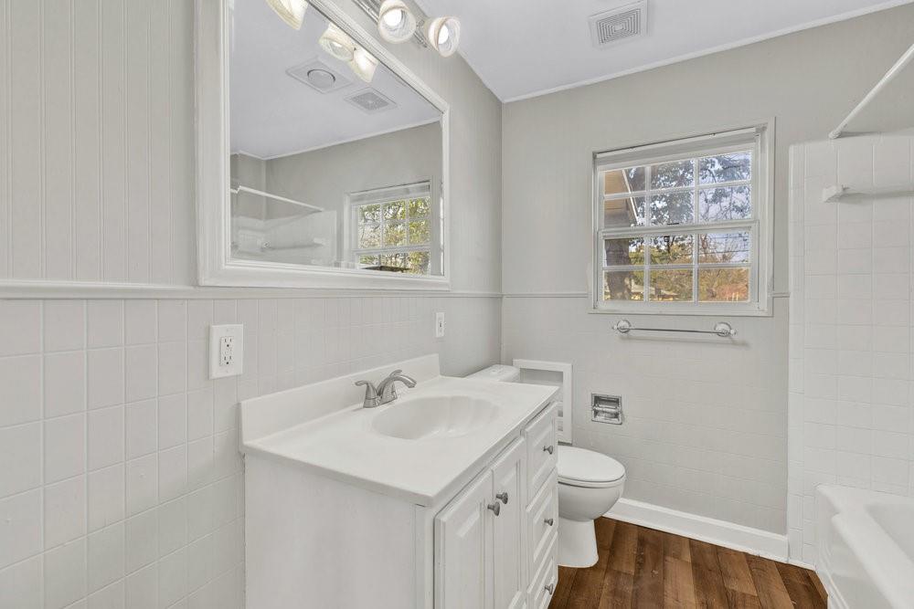 6833 Norma Street Fort Worth, TX 76112 - Photo 13 of 17 a bathroom with a toilet sink and mirror