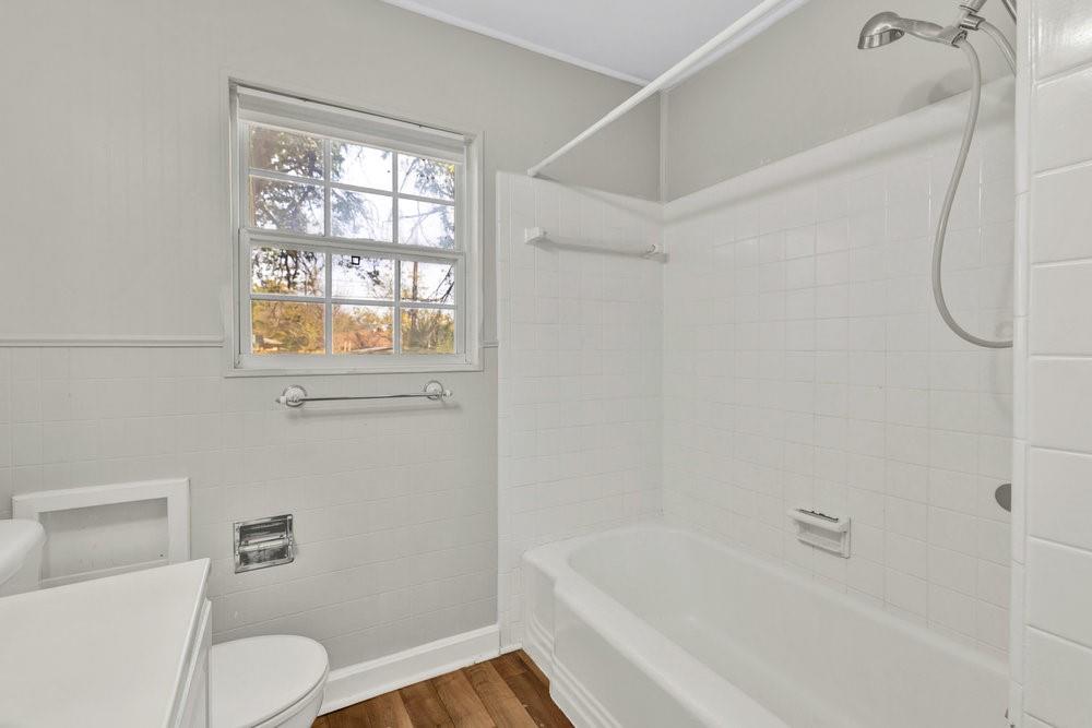6833 Norma Street Fort Worth, TX 76112 - Photo 14 of 17 a bath room with a toilet and a bath tub