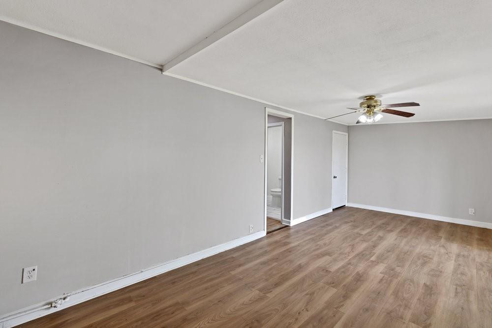 6833 Norma Street Fort Worth, TX 76112 - Photo 5 of 17 a view of an empty room with wooden floor