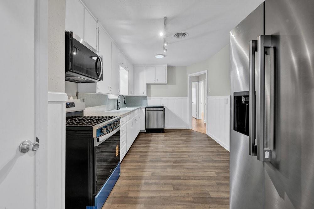 6833 Norma Street Fort Worth, TX 76112 - Photo 7 of 17 a large kitchen with stainless steel appliances and a refrigerator