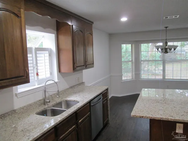 a kitchen with sink cabinets and window