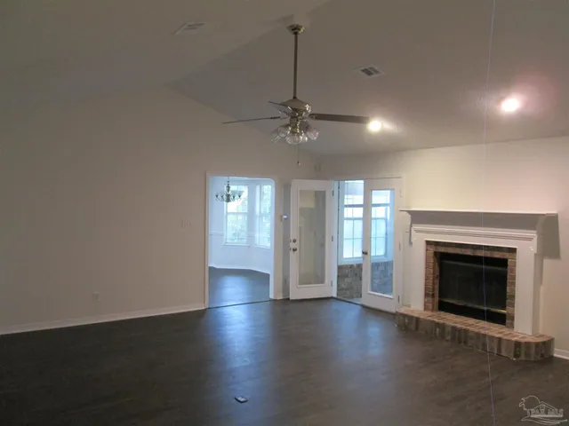 a kitchen with kitchen island a sink dishwasher a stove and a refrigerator with wooden floor