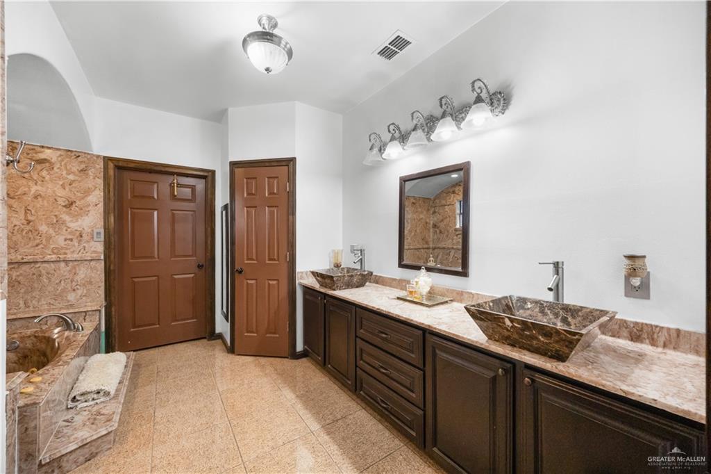 6813 North Gwin Road Edinburg, TX 78542 - Photo 13 of 20 a bathroom with a sink and a mirror