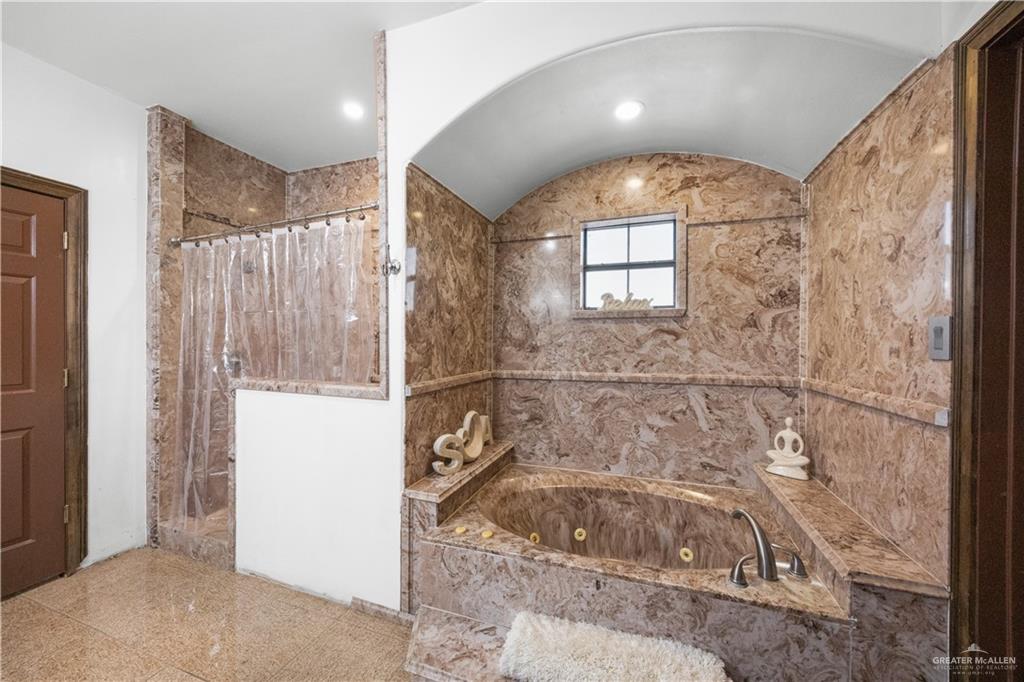 6813 North Gwin Road Edinburg, TX 78542 - Photo 14 of 20 a bathroom with a tub and shower