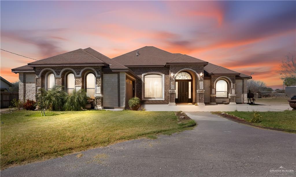 6813 North Gwin Road Edinburg, TX 78542 - Photo 2 of 20 a front view of a house with a yard