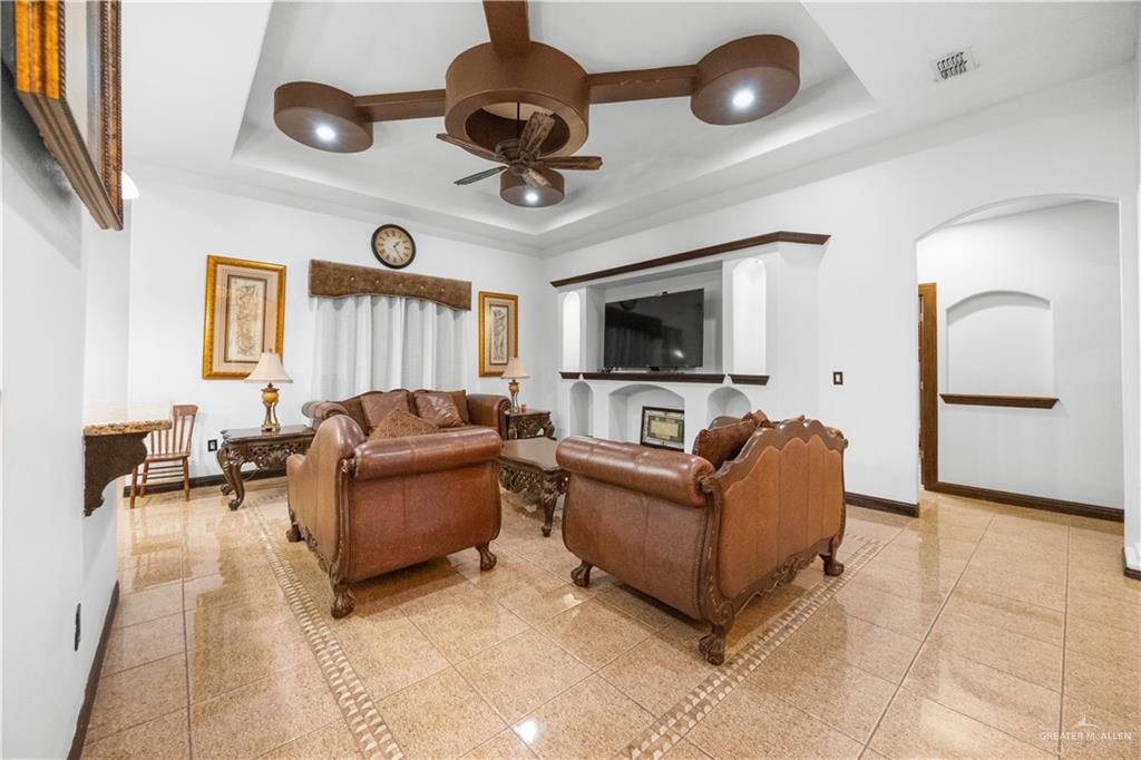 6813 North Gwin Road Edinburg, TX 78542 - Photo 7 of 20 a living room with furniture and a flat screen tv