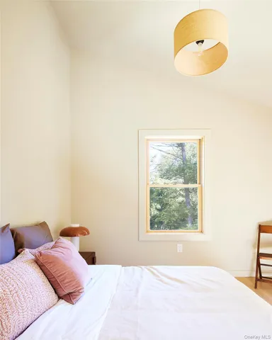 a bedroom with a bed and window