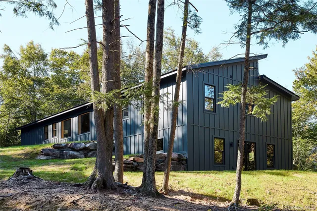 a backyard of a house with table and chairs