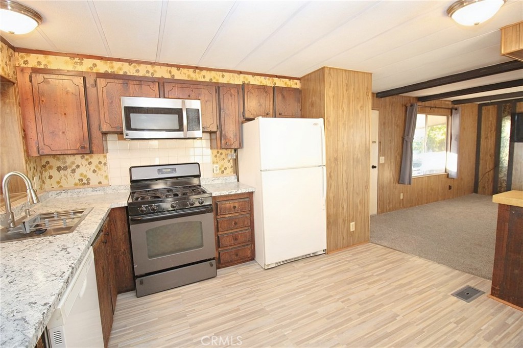 1155 Pease Road, Unit 24 Yuba City, CA 95991 - Photo 10 of 30 a kitchen with a refrigerator sink and stove