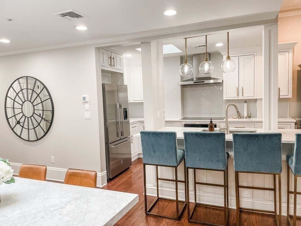 296 Commonwealth Avenue, Unit 5 Boston, MA 02115 - Photo 14 of 29 a kitchen with stainless steel appliances granite countertop a sink and a refrigerator