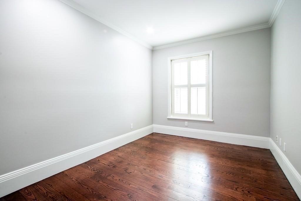 296 Commonwealth Avenue, Unit 5 Boston, MA 02115 - Photo 20 of 29 a view of an empty room with wooden floor and a window