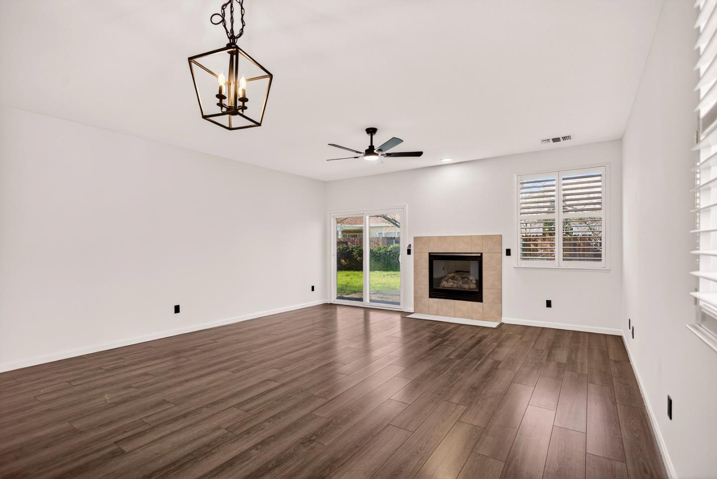 1825 Vermont Street Gridley, CA 95948 - Photo 12 of 57 a view of an empty room with wooden floor fireplace and a window