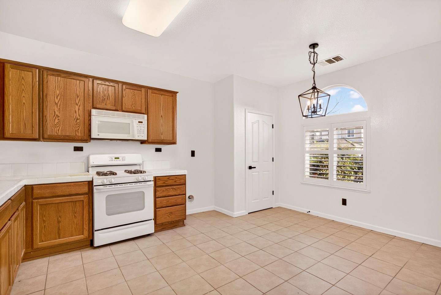 1825 Vermont Street Gridley, CA 95948 - Photo 19 of 57 a kitchen with stainless steel appliances granite countertop a stove a sink and a microwave