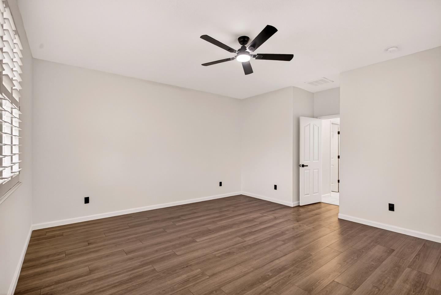 1825 Vermont Street Gridley, CA 95948 - Photo 25 of 57 an empty room with wooden floor and a ceiling fan