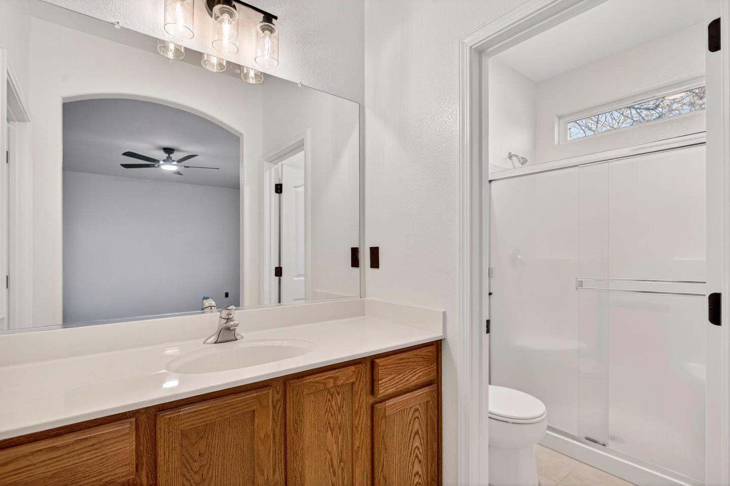 1825 Vermont Street Gridley, CA 95948 - Photo 27 of 57 a bathroom with a sink a toilet a mirror and shower