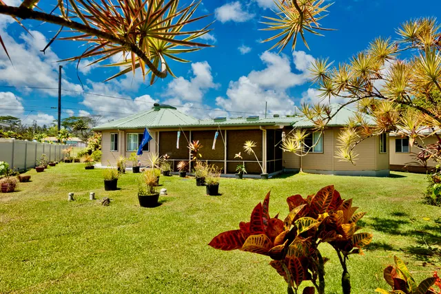 a view of a house with swimming pool and sitting area