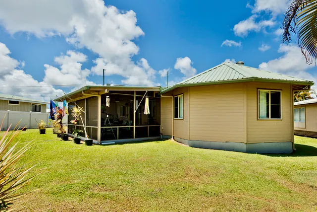 a view of a house with a backyard