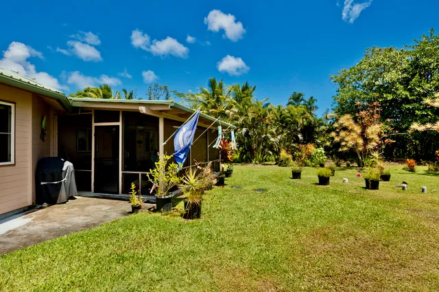a view of a porch with a table and chairs