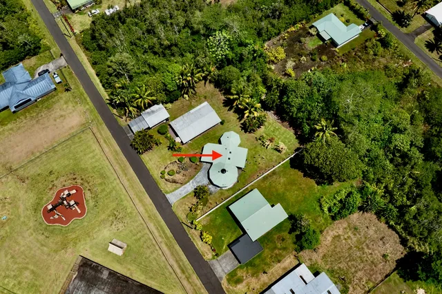 an aerial view of a house with a yard