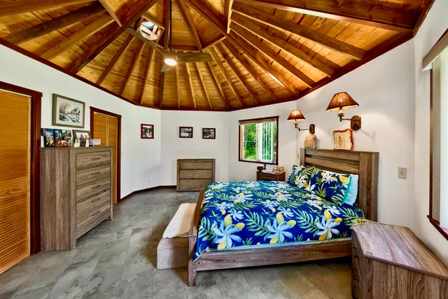 a bedroom with bed and wooden floor