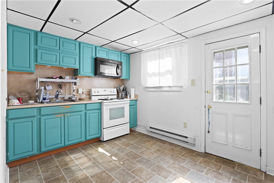 431 Pierce Street Bethlehem, PA 18015 - Photo 11 of 27 A compact kitchen with cheerful cabinetry and durable tiled flooring.