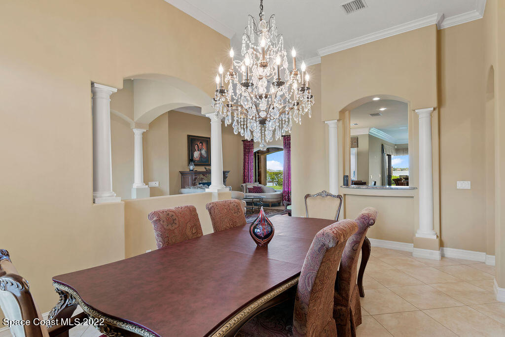 1 Pisces Lane Rockledge, FL 32955 - Photo 13 of 61 a view of a dining room with furniture and chandelier