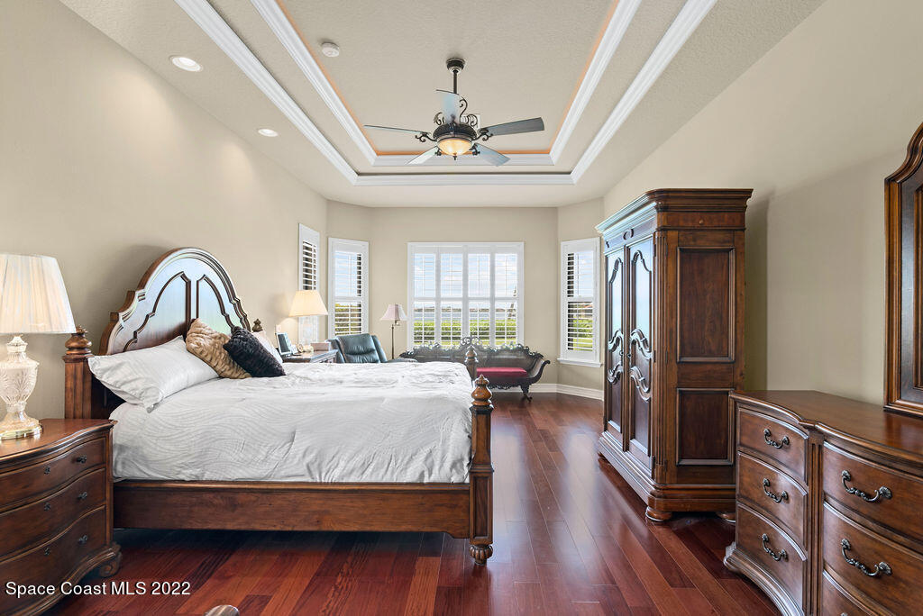 1 Pisces Lane Rockledge, FL 32955 - Photo 18 of 61 a bedroom with a bed and a chandelier