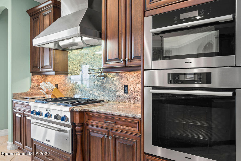 1 Pisces Lane Rockledge, FL 32955 - Photo 27 of 61 a kitchen with stainless steel appliances granite countertop a stove microwave and oven