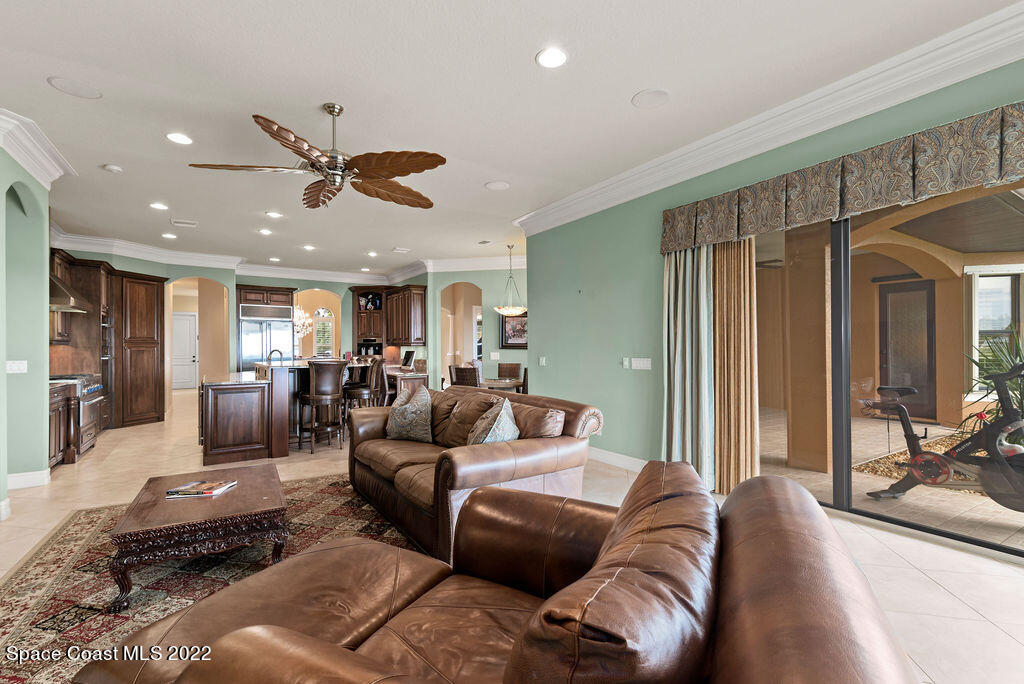 1 Pisces Lane Rockledge, FL 32955 - Photo 32 of 61 a living room with furniture ceiling fan and a rug