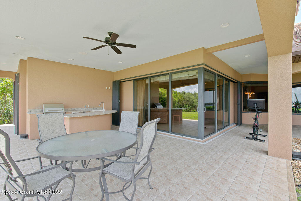 1 Pisces Lane Rockledge, FL 32955 - Photo 34 of 61 a living room with furniture a large window and stainless steel appliances