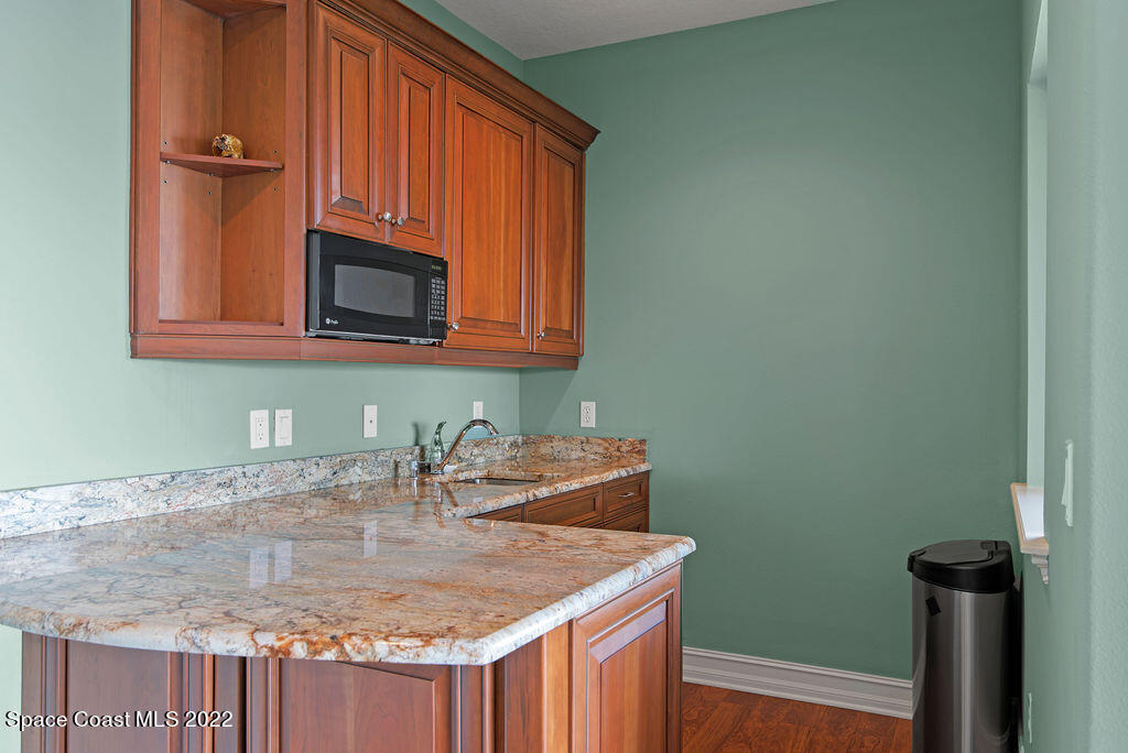 1 Pisces Lane Rockledge, FL 32955 - Photo 40 of 61 a kitchen with sink cabinets and microwave