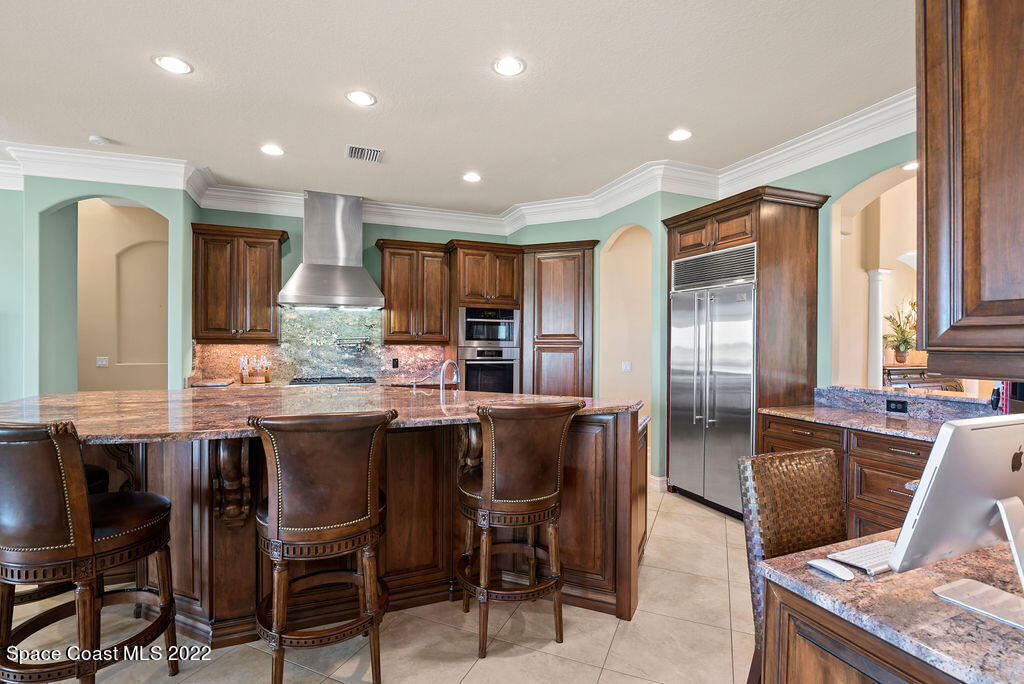 1 Pisces Lane Rockledge, FL 32955 - Photo 4 of 61 a dining hall with stainless steel appliances kitchen island granite countertop a table and chairs